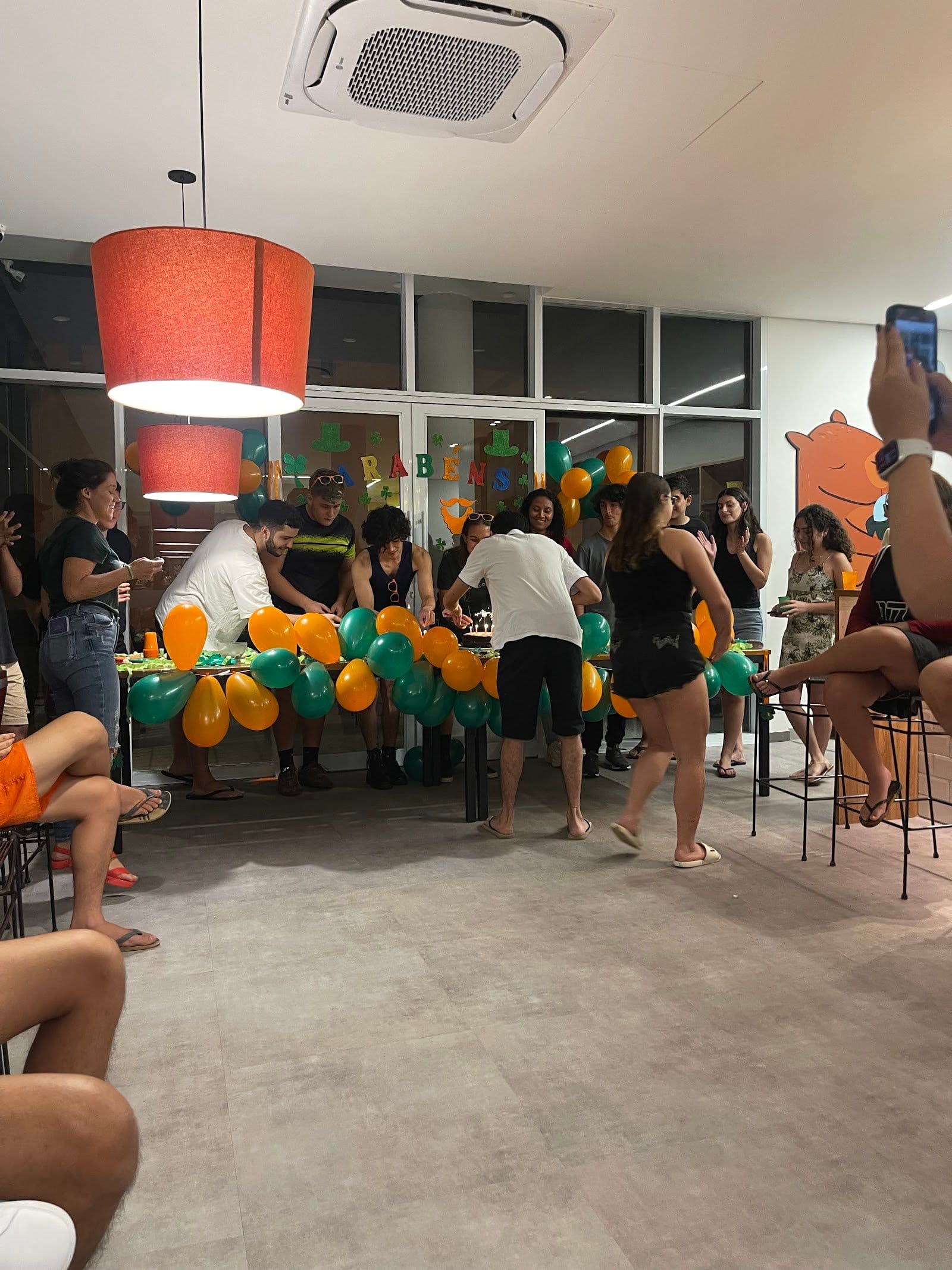 Residents socializing at a celebration in the common area of Uliving Campinas