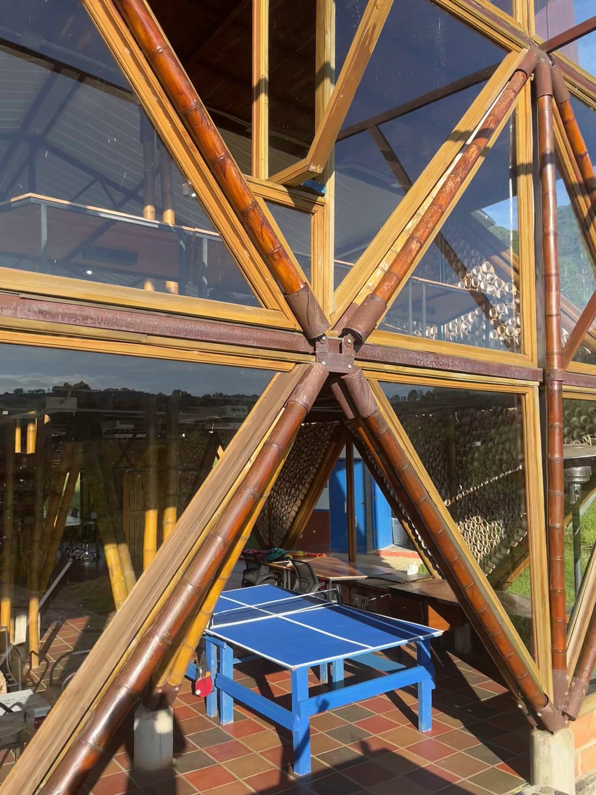Riverside ecoliving window-side work desk with monitor and laptop overlooking the green valley