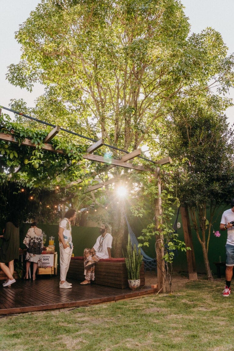 Residents gathered in the lush golden-hour garden at Coliving Muni in Florianopolis