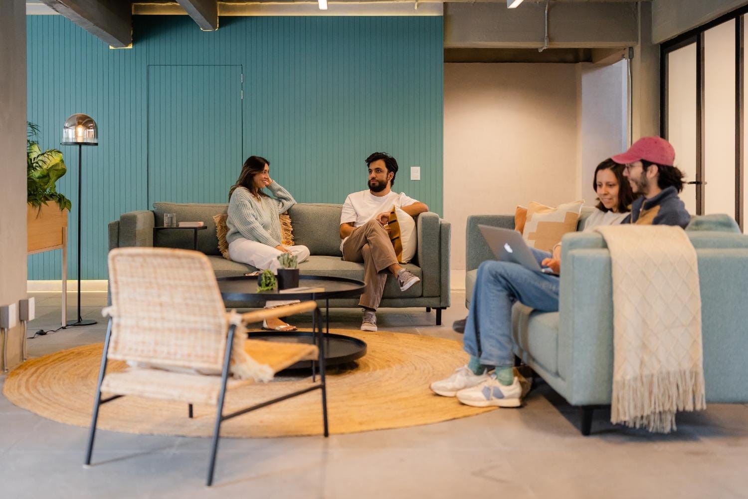 Four residents chatting together in the lounge at Outsite Mexico City Roma Sur