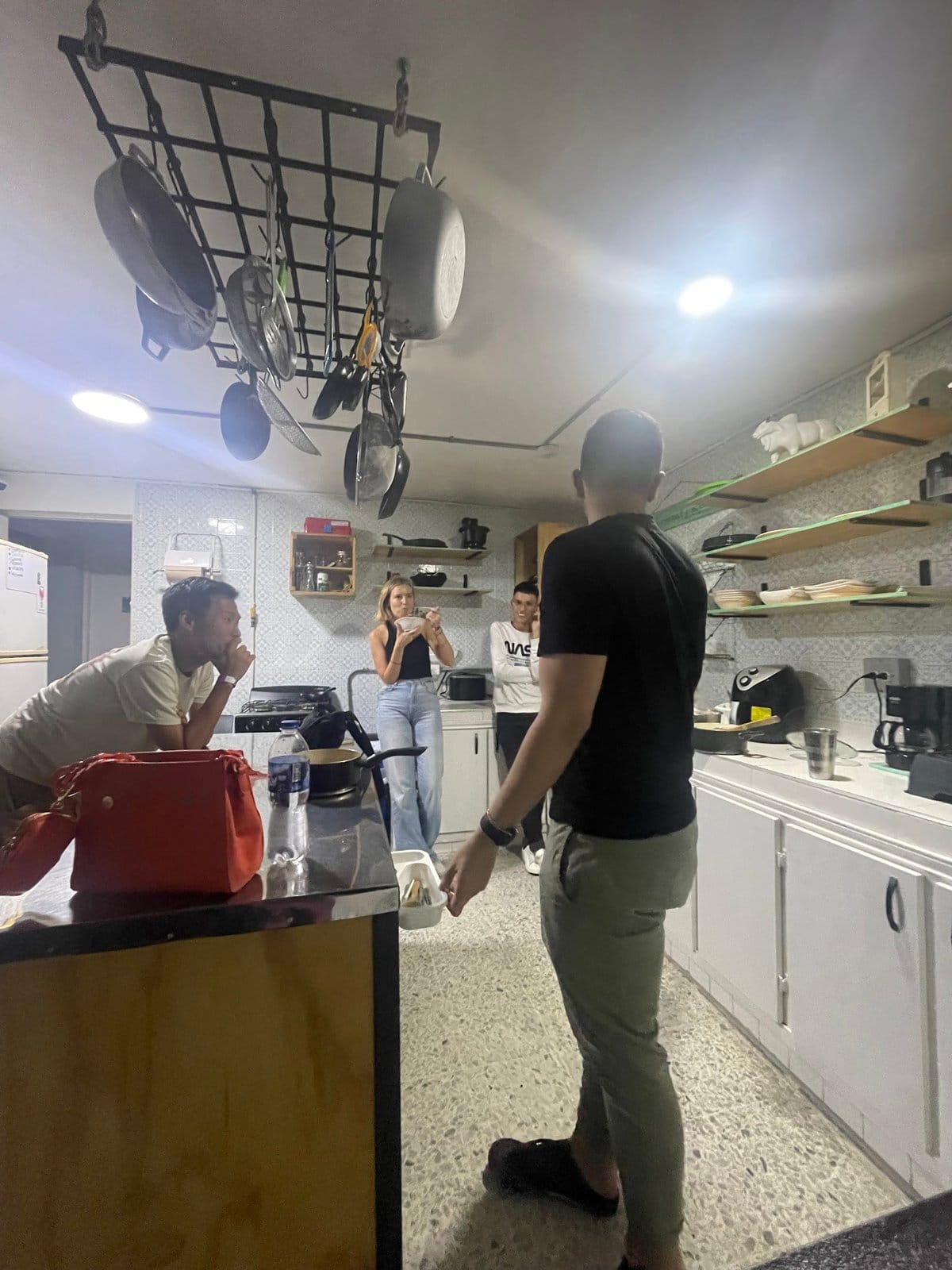 Residents socializing together in the shared kitchen at Pandora's House Coliving