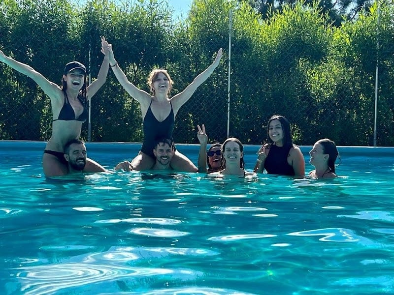 Group of seven Co404 residents enjoying the pool together