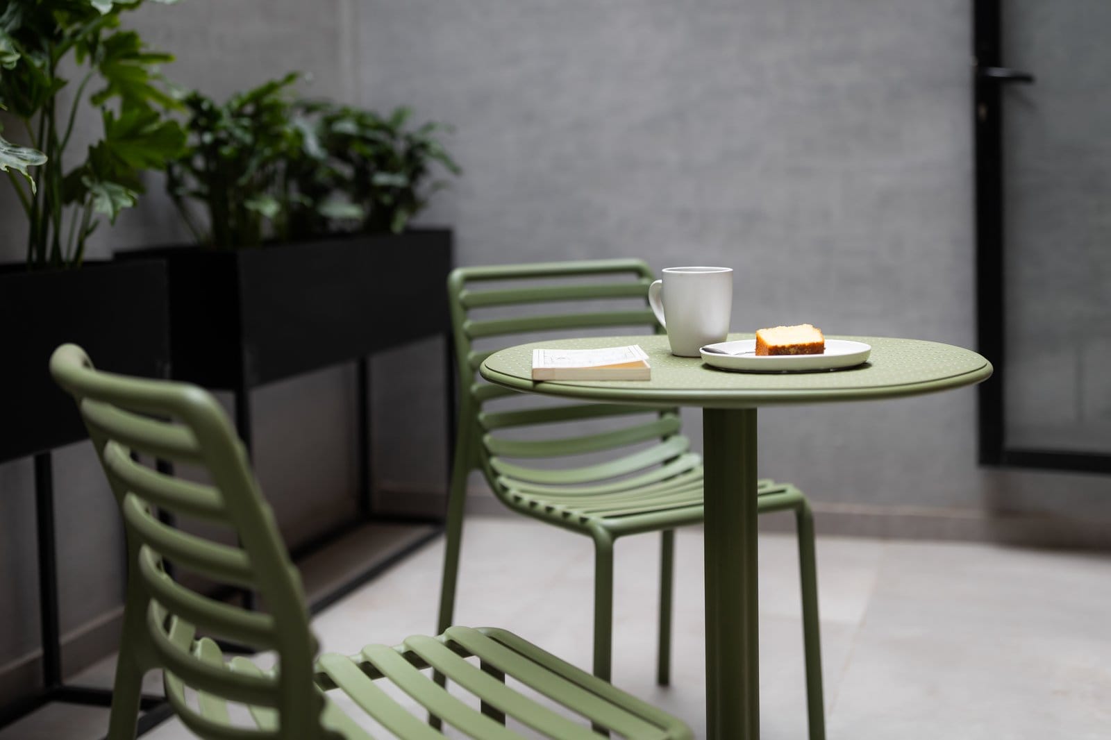 Morning coffee and a book on the outdoor terrace at Outsite Mexico City Roma Sur
