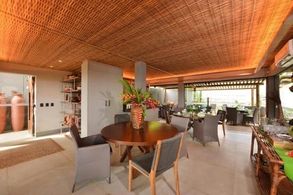 Covered open-air communal dining and lounge terrace with bamboo ceiling at Pousada Maria Bonita, Fernando de Noronha