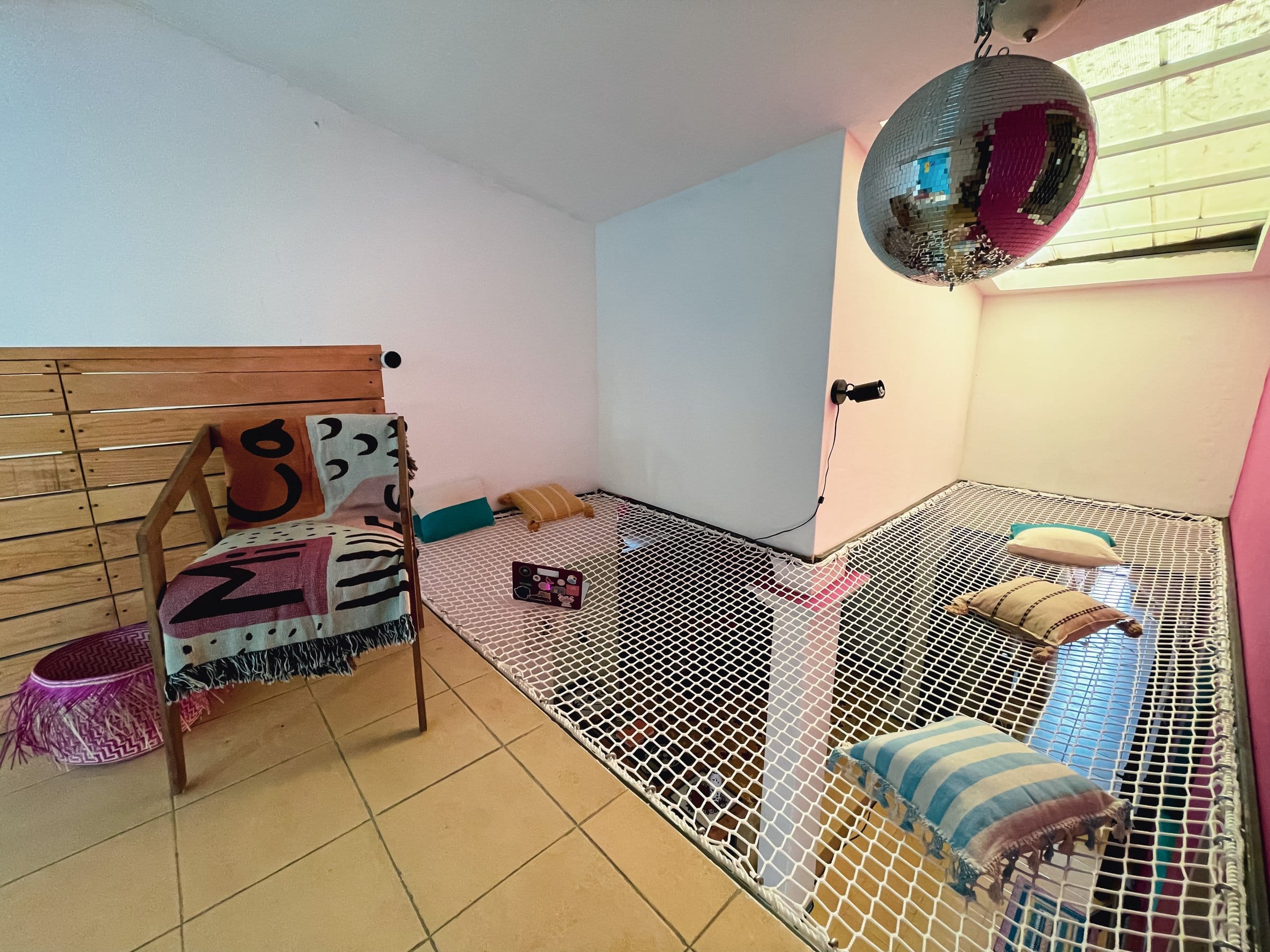 Net hammock lounge with pillows and disco ball at Aldea Tuya | 220, Oaxaca