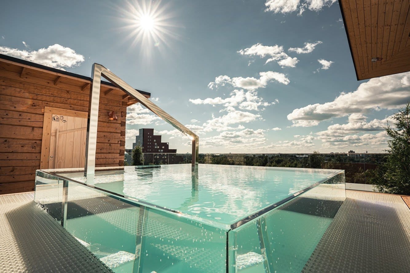 Modern glass-walled rooftop pool overlooking Helsinki at VALO Hotel & Work