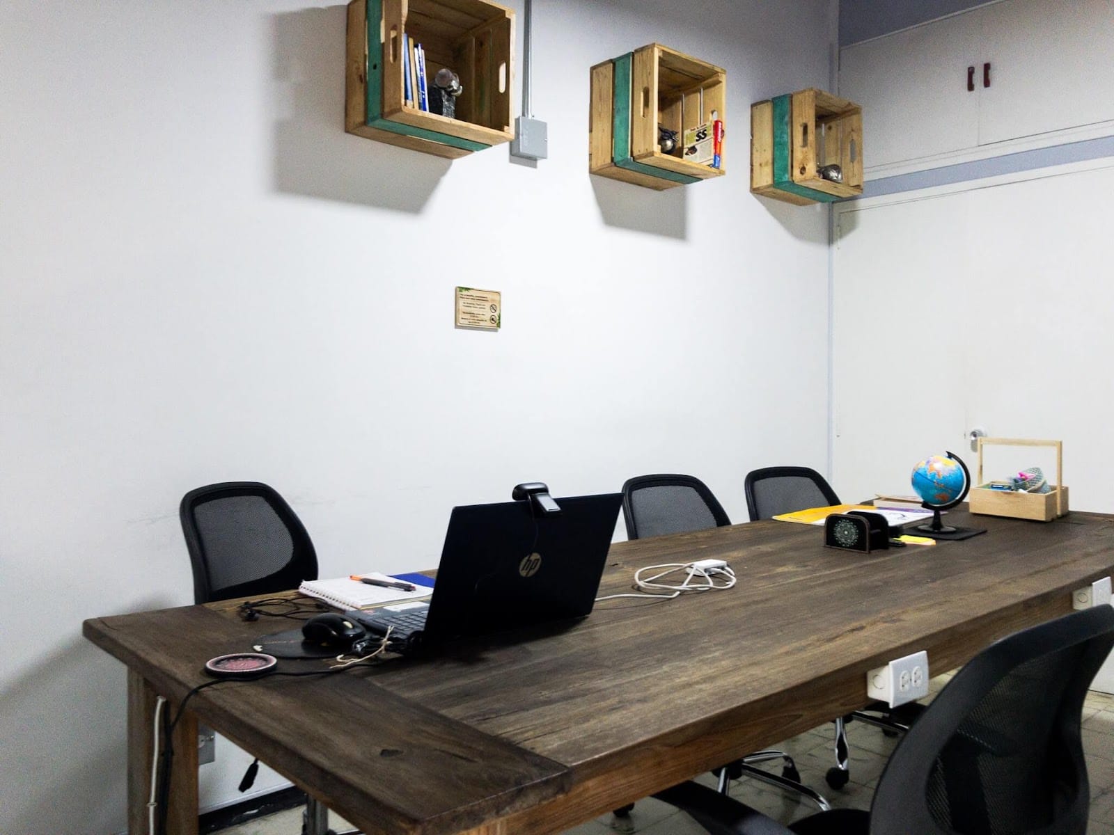 Dedicated coworking room at Pandora's House Coliving with a long wooden desk, ergonomic chairs and natural light