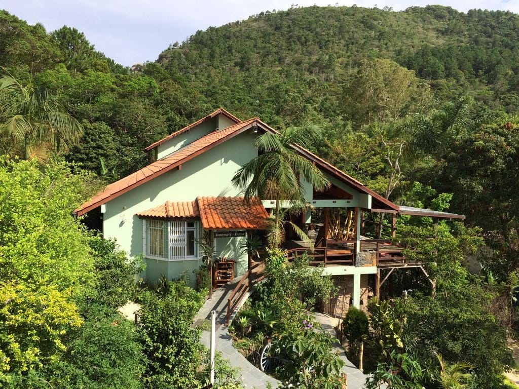 Green hillside building surrounded by Atlantic forest at Rosemary Dream Hostel & Coliving, Florianópolis