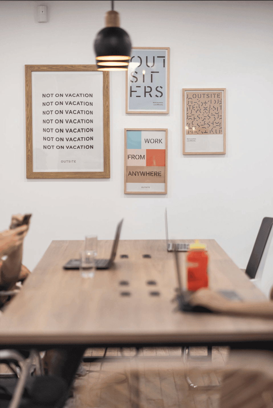 Coworking table with laptops and members working at Outsite Medellín