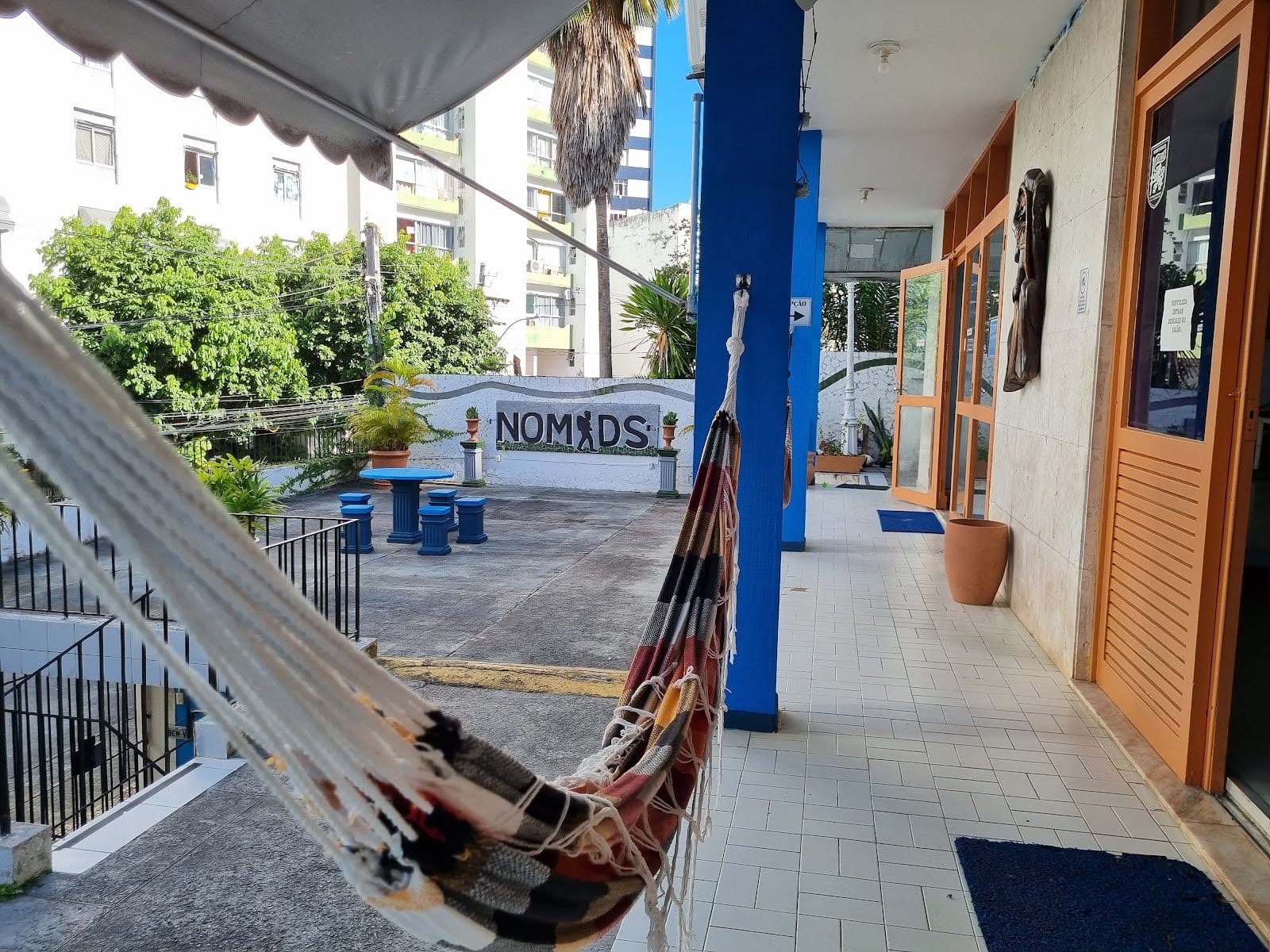Terrace with hammock and the painted NOMADS mosaic wall at Nomads Multiespaço, Salvador