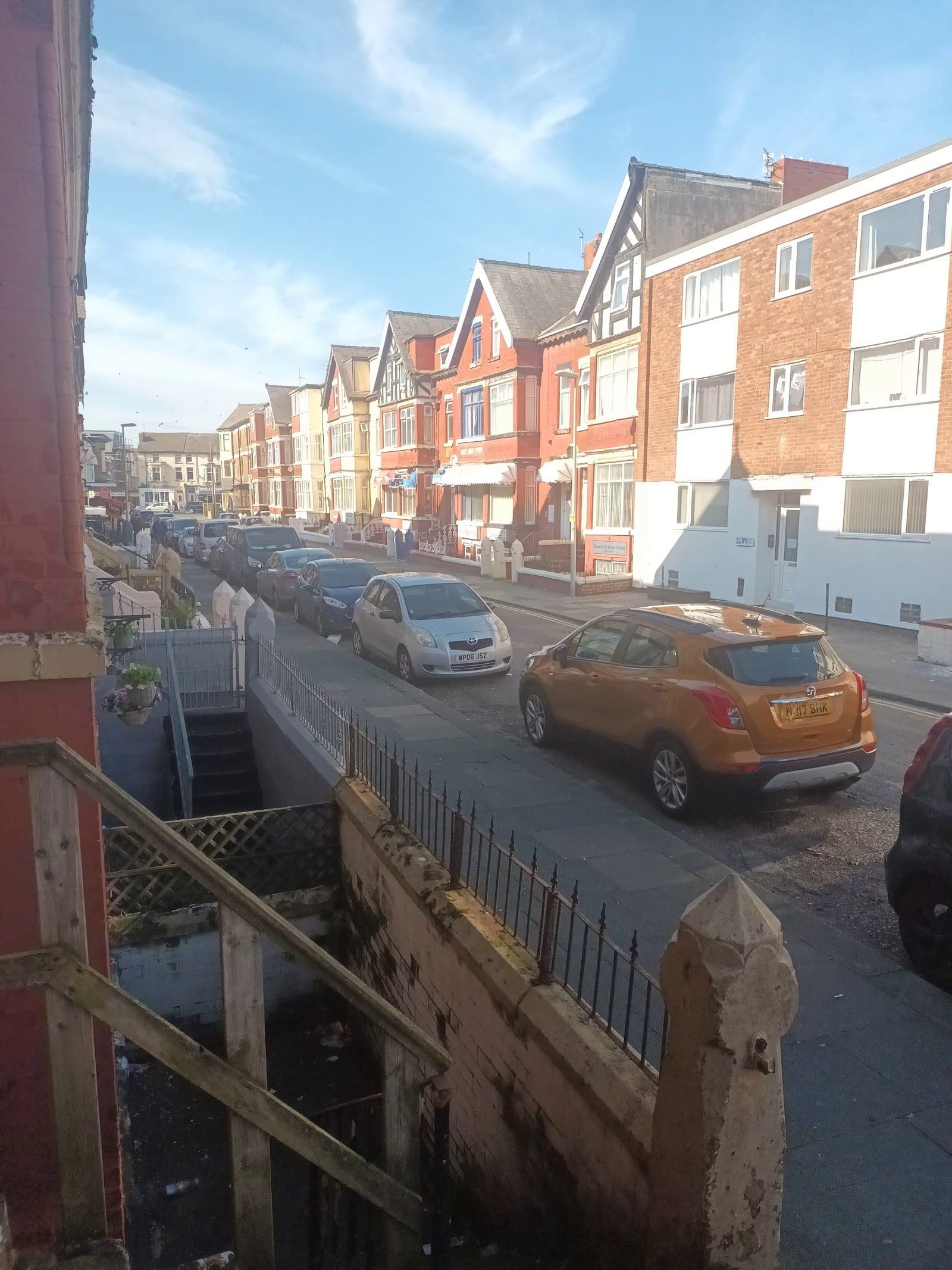 View from the house onto the quiet South Shore residential street lined with colorful Victorian terraces in Blackpool