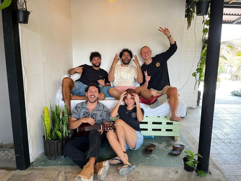 Residents hanging out with a guitar on the patio couch at Co404 Medellin