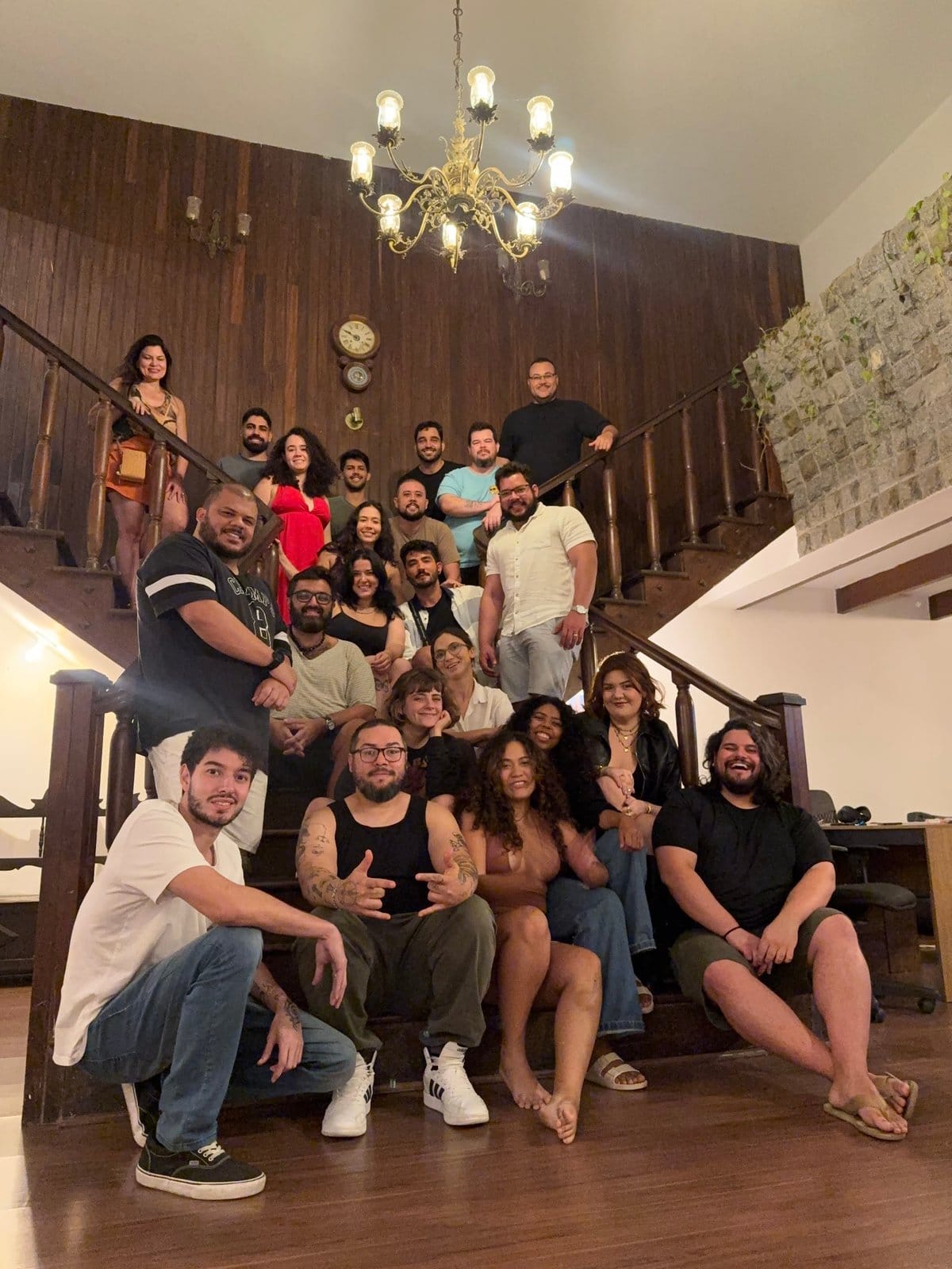 Residents gathered together on the wooden staircase at Horizonte Coliving