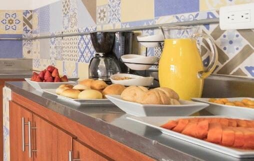 Breakfast spread at Gastón Coliving with fresh bread, fruit, juice, and coffee