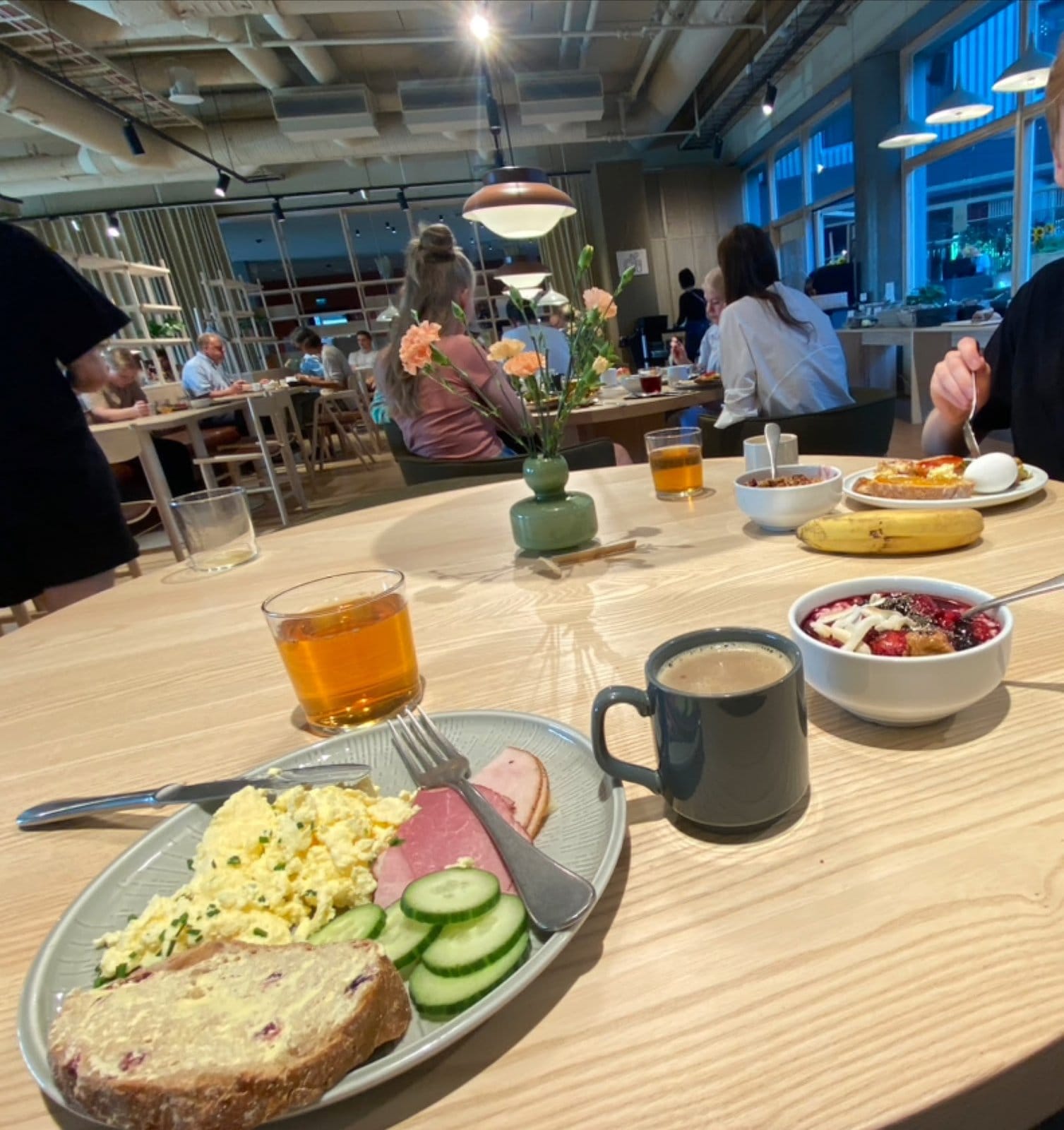 Guests enjoying breakfast and socializing in the dining area at VALO Hotel & Work