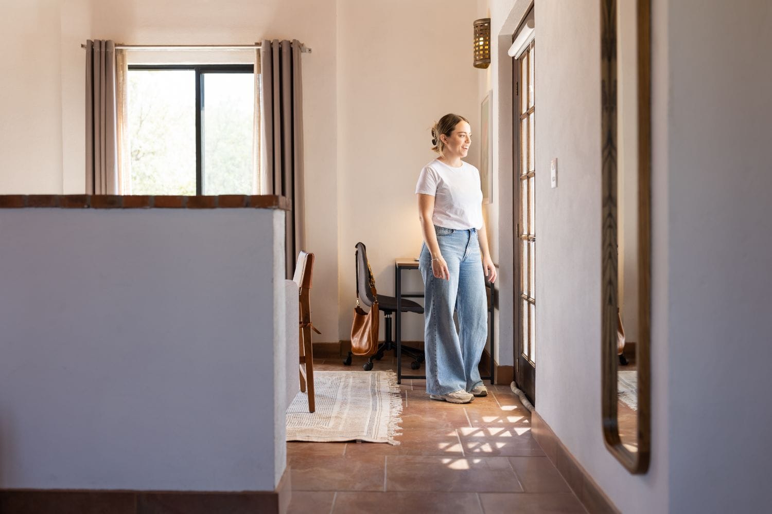 Guest exploring the bright interior hallway and common spaces at Outsite San Miguel de Allende