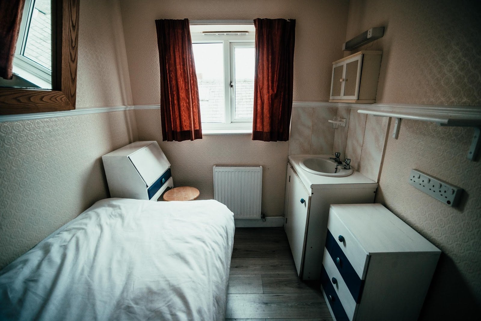 Compact private bedroom with single bed, sink unit, wardrobe, and window at Somewhere Different, the digital nomad coliving house in Blackpool