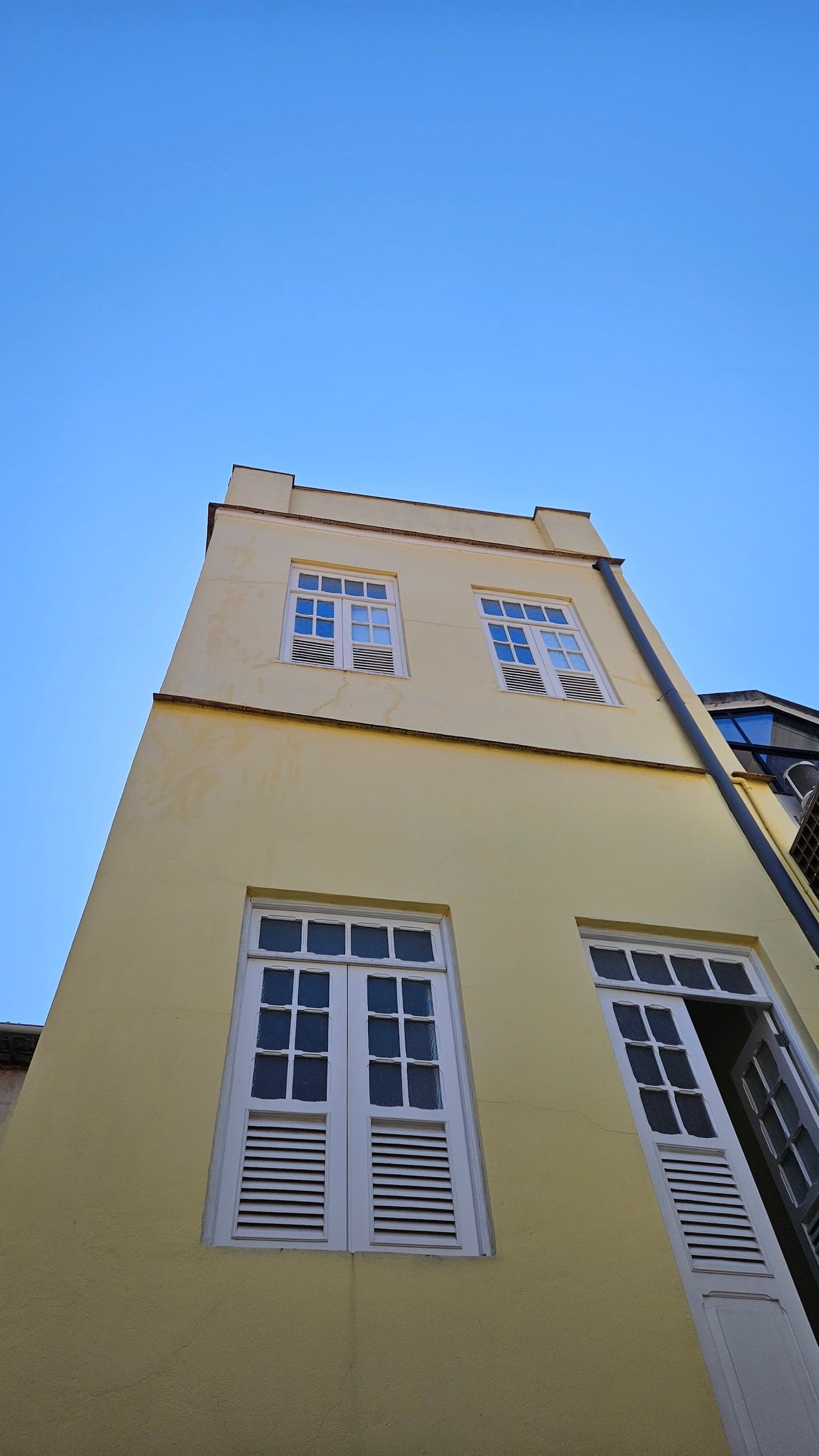 Historic yellow facade of Draper Startup House by Lawi startup house in Rio de Janeiro