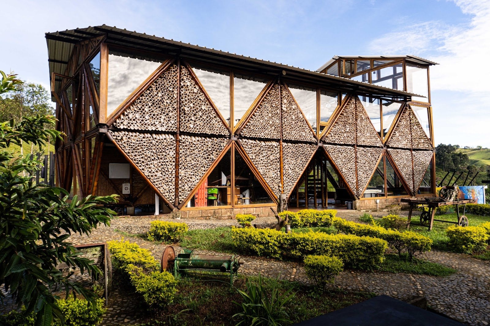 Riverside ecoliving distinctive bamboo-and-timber geometric clubhouse set in a landscaped garden